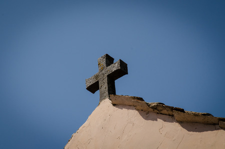 single stone cross over blue skyの写真素材