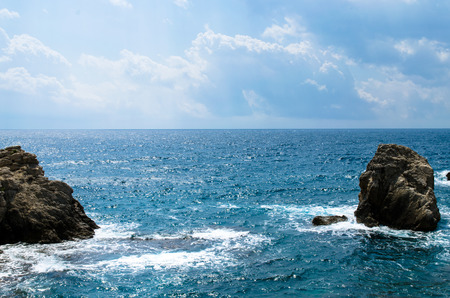 rocks in the blue sea imageの写真素材