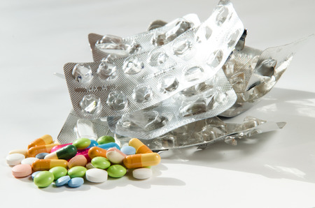 group of pills and silver empty pills blister isolatedの写真素材