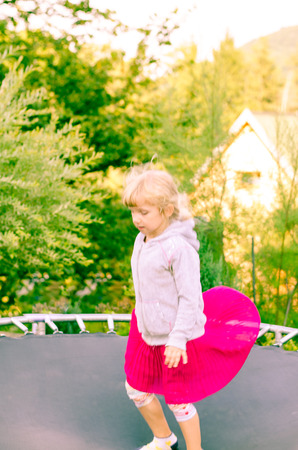beautiful blond girl jumping imageの写真素材