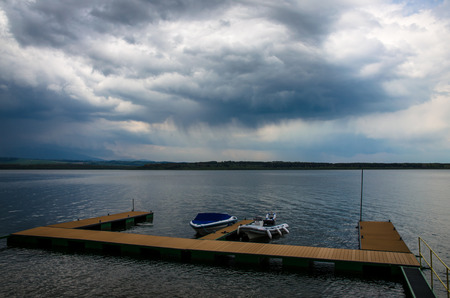 boats on the lake before the rainのeditorial素材