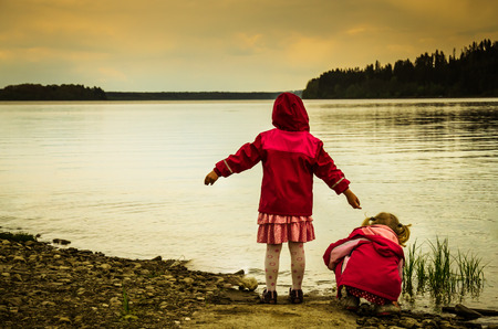 two girls children at the lakeの写真素材