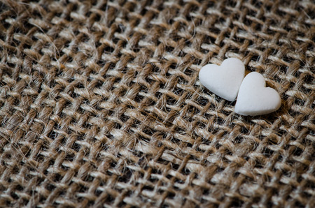 two white hearts on brown background