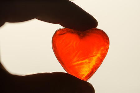 detail of red heart in hand