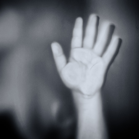 human hand touching glass black and white effectの写真素材