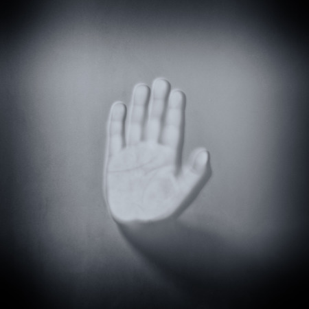 human hand touching glass black and white effectの写真素材