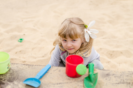 beautiful blond girl child playing on the playgroundの写真素材