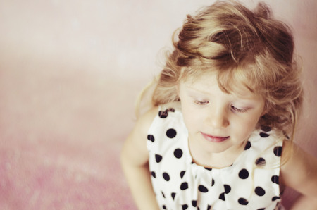 beautiful child girl with long blond hair and closed eyesの写真素材