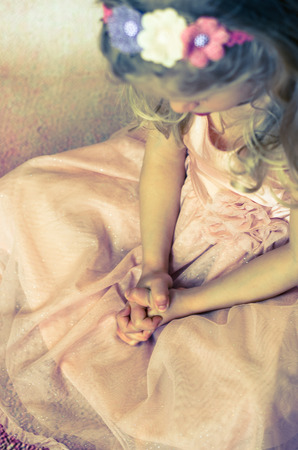 blond girl praying with her handsの写真素材