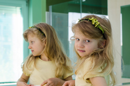 beautiful blond girl reflection in mirrorの写真素材