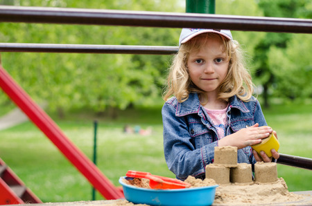 beautiful blond girl playing in playgroundの写真素材