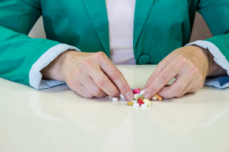 human hands and colorful pillsの写真素材