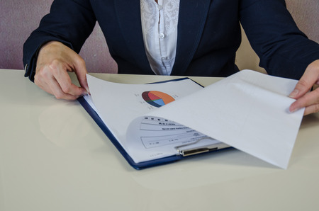 female hand with survey on paper