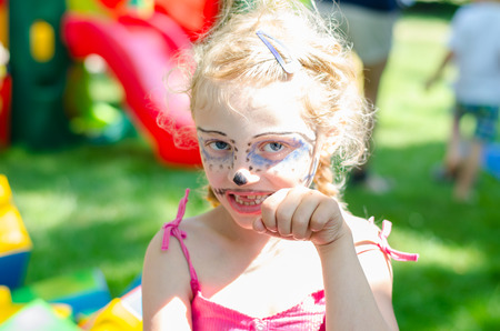 blond child with blue facepainting