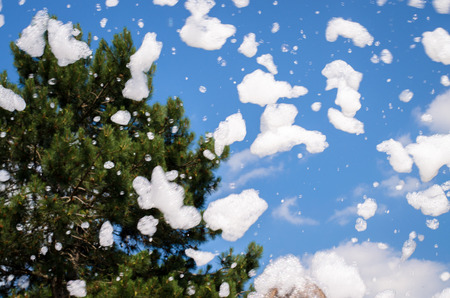 flying white pieces of soap foamの写真素材