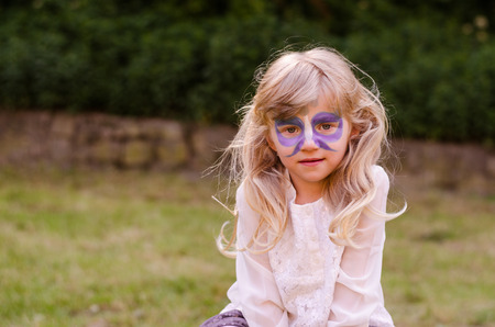 girl with facepainting of blue butterfly