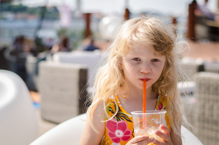 beautiful blond girl with drinkの写真素材