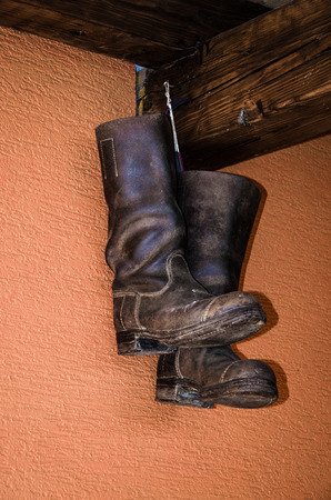 boots hanged on the wallの写真素材