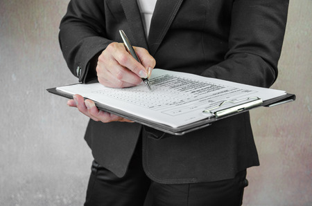 business concept with pen and questionnaire