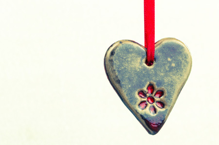 hanged brown ceramics heart isolatedの写真素材