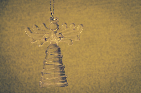 crystal angel decoration against blue backgroundの写真素材