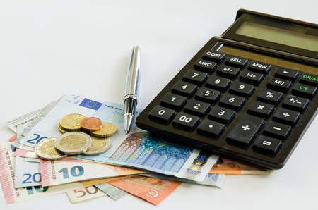 banknotes,coins, calculator and pen