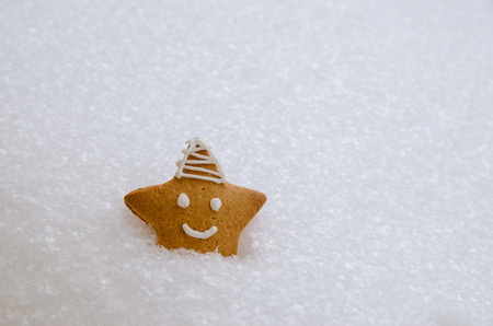 christmas snowbounded gingerbread star in white snowの写真素材