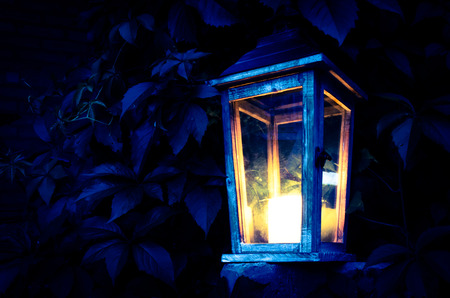 burning candle in the wooden lanternの写真素材