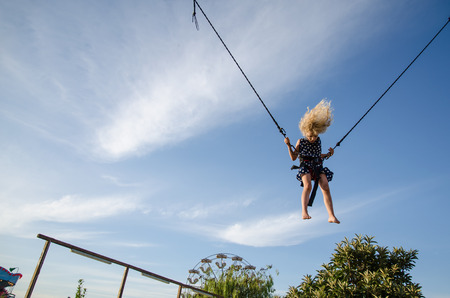 little courageous kid jumping in bungee attraction