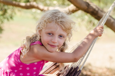 beautiful smiling blond little girl portraitの写真素材