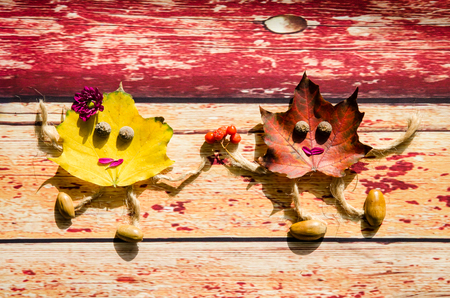 couple made of yellow and red autumn leavesの写真素材