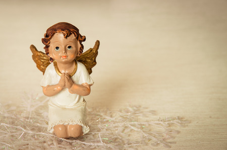 innocent praying angel with playing gestureの写真素材