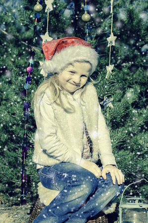sitting girl with christmas decorationの写真素材