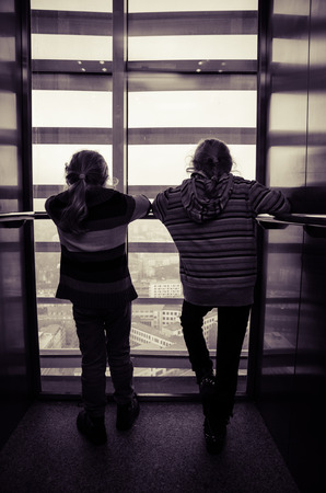 little children standing in the liftの写真素材