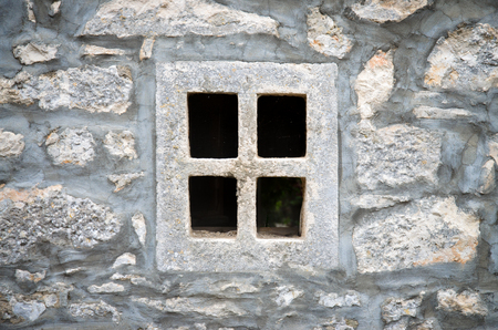 gray stone window in wallの写真素材