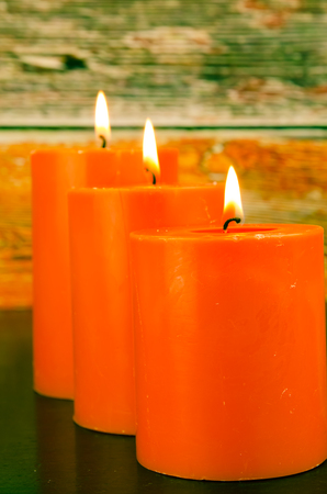 burning orange candles still lifeの写真素材