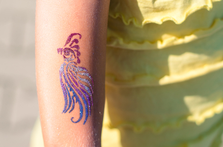 children cool colorful tattoo on the handの写真素材