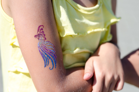 children cool colorful tattoo on the handの写真素材