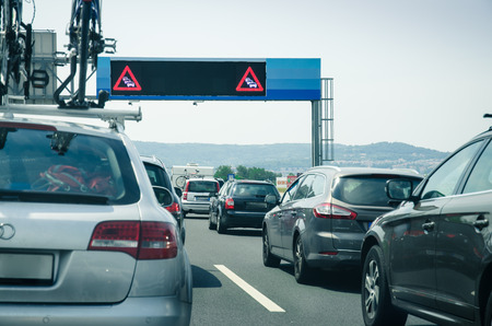 convoy traffic jam road sign and cars on the roadの写真素材