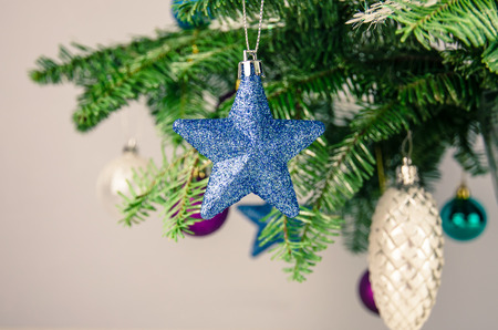colorful christmas baubles in christmas tree detailの写真素材