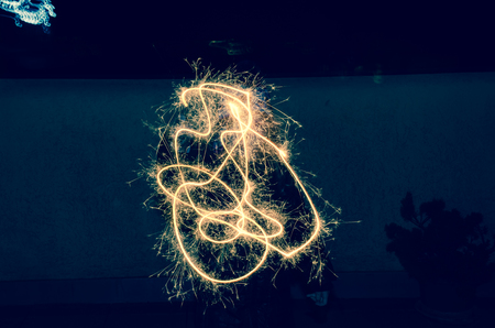 girl holding ski-rocket at new years eveの写真素材