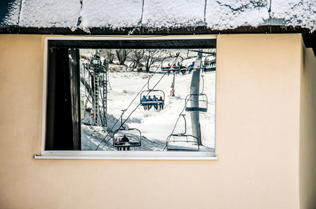 ski tow with skiers reflection in windowの写真素材