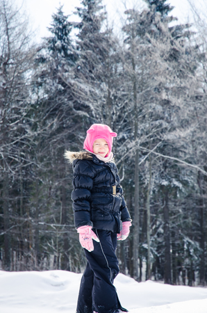beautiful little child in winter forestの写真素材