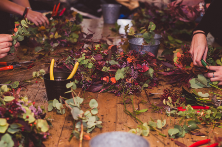 hands with tools for seasonal decorative bouquet from dried flowers preparationの写真素材
