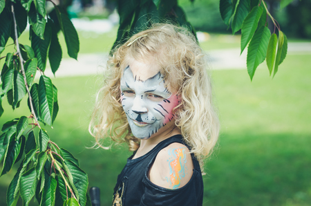 little lovely blond girl with cat facepainting の写真素材