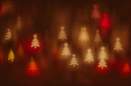 colorful christmas tree bokeh against dark backgroundの写真素材
