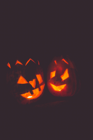 two orange halloween pumpkins at nightの写真素材