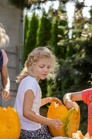 lovely blond girls with orange autumn pumpkins の写真素材