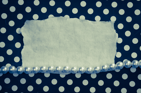 pearls, blank board and white blue dotted backgroundの写真素材