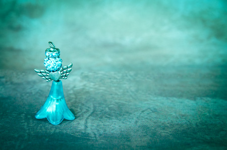crystal angel decoration on blue backgroundの写真素材